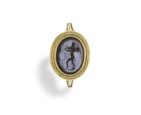  A Roman glass intaglio with Cupid playing the aulos Circa 1st Century A.D. The glass imitating nicolo, mounted in a late 18t