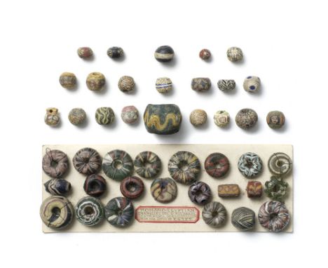  A group of Roman and later glass beads Roman-Islamic Periods, circa 1st Century B.C.-9th Century A.D.Including four Roman gl