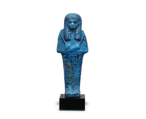  An Egyptian bright blue glazed faience shabti for Nes-ta-nebt-Isheru Third Intermediate Period, 21st Dynasty, circa 980-935 