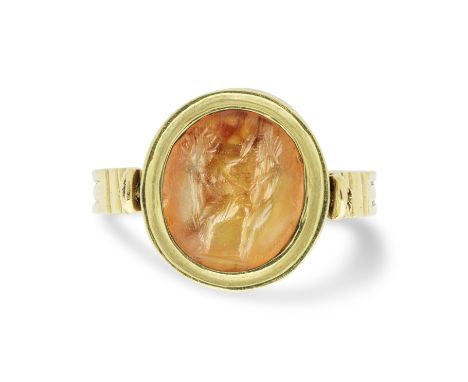  A Roman carnelian intaglio with an erotic scene Circa 2nd-3rd Century A.D. Set in a modern gold swivel ring, intaglio 1.2cm 