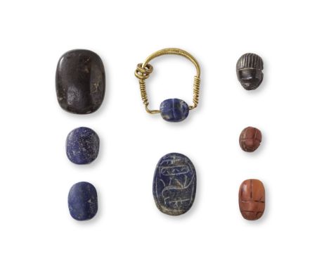  An Egyptian gold and lapis swivel ring, four hardstone scarabs and a serpentine scaraboid  Middle Kingdom - early New Kingdo