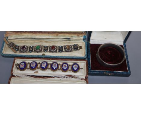 A gilt white metal and cabochon gem set bracelet, one other and a white metal bangle.