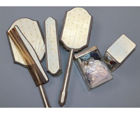 A George V silver and enamel six piece dressing table set.