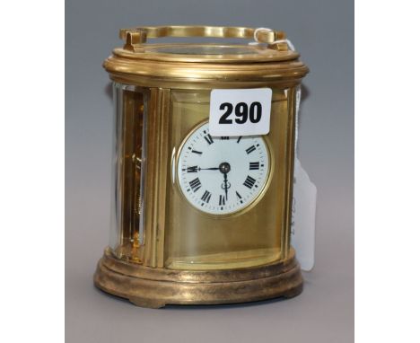 An Edwardian oval brass carriage clock, with travelling case height 13cm
