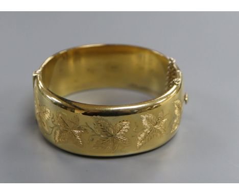 A modern silver gilt hinged bangle.