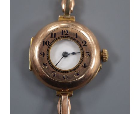 A lady's early 20th century 9ct Rolex half hunter manual wind wrist watch, on a yellow metal flexible strap.