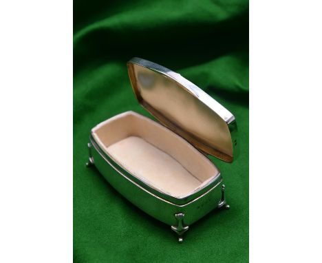 A silver trinket box on raised feet with blue guilloché enamel panel in lid and padded interior. Hallmarked Birmingham 1943, 