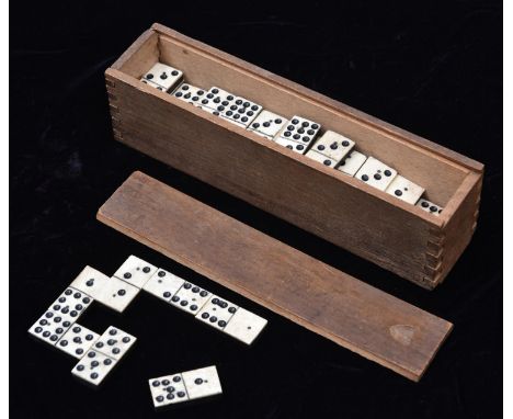 A 19th Century Domino set. 49x playing pieces of bone and ebony (or ebonised wood) construction, each with two brass pins hol
