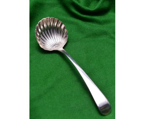 A Georgian silver sauce ladle with shell shaped bowl and decorated handle. Hallmarked London 1782, 'GS' for George Smith. 48g