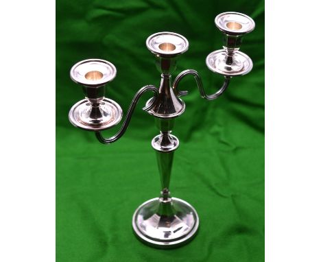 A silver candelabra with two arms and 3 removable sconces. Circular base, octagonal faceted base, colomn and capitals and wei
