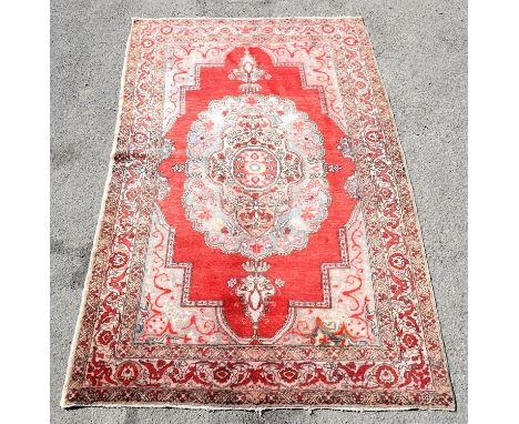 Vintage Iranian rug with central medallion on a red ground within a floral border, 247 x 153cm 
