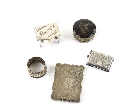 Group of silver items to include a card case, vesta case, plated stamp box in the form of a desk, silver napkin ring and a si