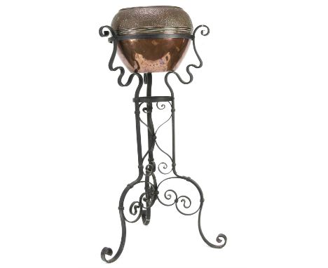 Early 20th century hammered copper planter on wrought metal stand, 97cm high, 