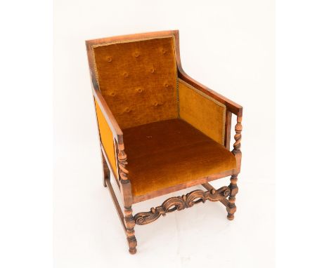 Mahogany armchair with mustard button back upholstery, with barley twist supports to arms, on turned legs joined by stretcher