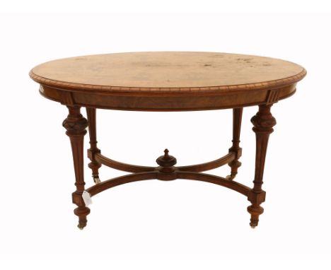 Late 19th century burr walnut oval dining table on turned and reeded legs united by an X-stretcher with a central urn finial,