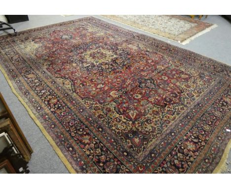 A Tabriz carpet, Iranian Azerbaijan, the deep raspberry field of floral vines around an indigo medallion, framed by spandrels