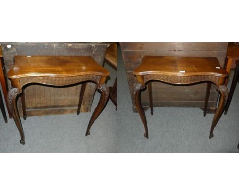 A pair of carved serpentine fronted console tables 