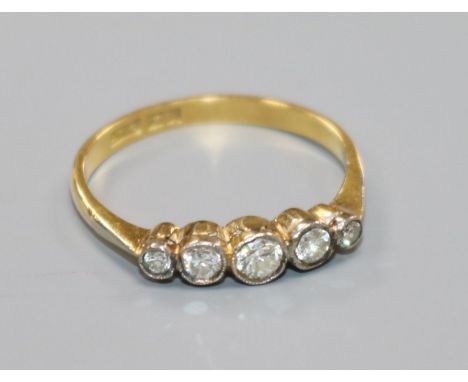 An 18ct gold and graduated five stone diamond ring, size R.