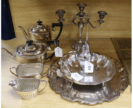 A four-piece plated tea service and a plated tray, candelabrum, swing-handled basket and caster