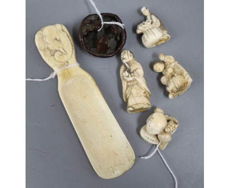 A group of Japanese ivory netsuke and other small carvings, including a shoehorn with elephant handle, a 'Clams Dream' shell 