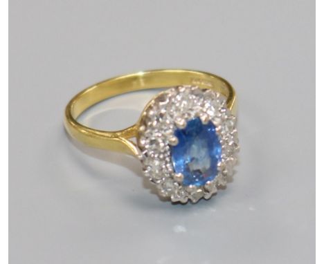 An 18ct gold, sapphire and diamond set oval cluster ring, size O.