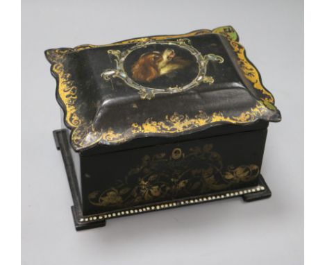 An early Victorian papier mache rectangular tea caddy, the interior with two covered sections, painted with gold scrolling fo