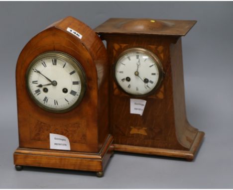 A late Victorian satinwood and burr walnut lancet-shaped mantel clock, and an Edwardian Art Nouveau oak and marquetry inlaid 