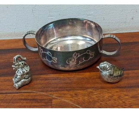 A silver pin cushion fashioned as a bird, a silver model, elephant and a silver plated Christening bowlLocation: 