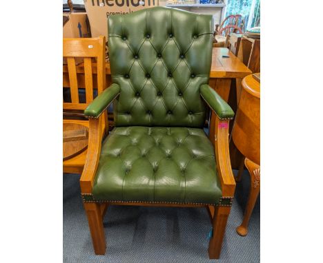 A modern green leather upholstered button back armchairLocation: 