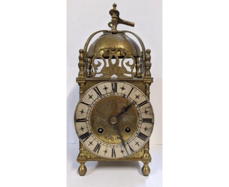 Circa 1900 a 17th century style lantern clock with a bell top surrounded by pierced panels, fitted with a Samuel Marti 8-day 