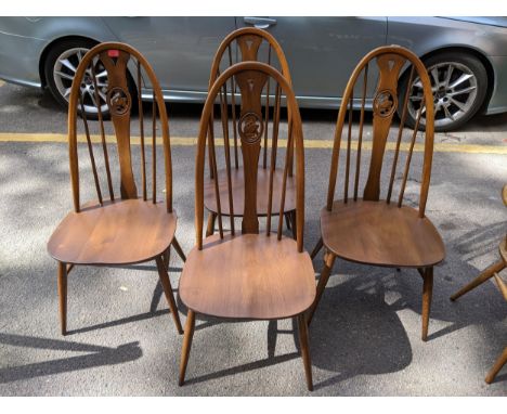 A set of 4 Ercol Windsor swan back standard dining chairs. 