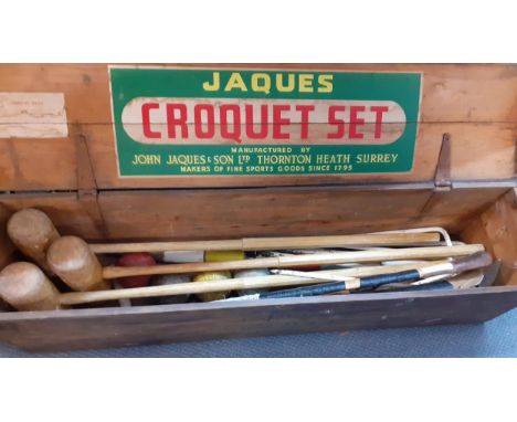 A vintage Jaques croquet part set comprising 3 mallets, 4 balls, 6 hoops, and various posts, in original wooden box, together