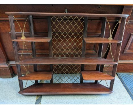 A late 20th century mahogany and brass six-tier wall shelf 72cm h x 90cm w Location: 