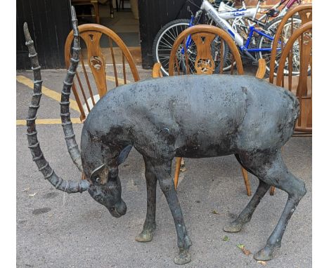 A large cast metal model of an Impala standing head down, 114cm high at highest point Location: G 