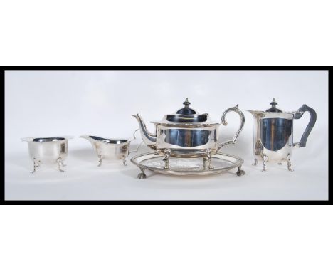 A collection of 20th Century silver plate items to include creamer jug, sugar bowl, engraved tray, a tea pot with a scrolled 