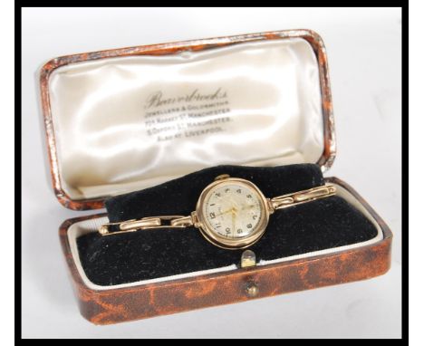 A vintage mid 20th Century hallmarked 9ct gold ladies cocktail watch by Lancet, champagne dial with gilt numeral chapter ring