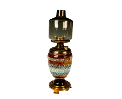 Tall oil lamp with brass-alloy base; earthenware body with ornate detailed floral and leaf design in low-relief; metal oil an