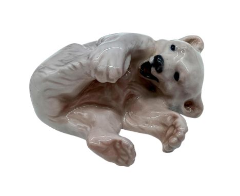 A glazed figure of a young polar bear playing. Royal Copenhagen backstamp. Model number 729. Issued: c. 1950sDimensions: 5""L