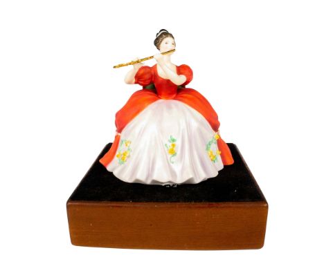 Limited edition in matte finish modeled as a lady musician in red and white floral dress playing flute. Part of the Lady Musi