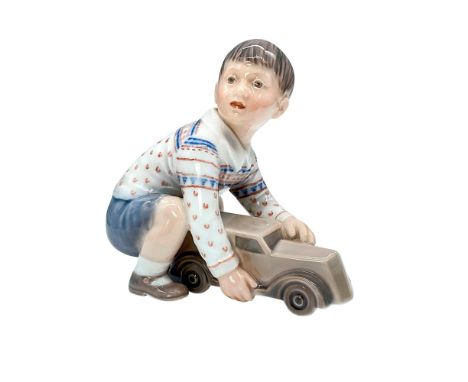 Dahl Jensen figurine of boy with toy car. DJ Copenhagen backstamp. Artist: Jens Peter Dahl JensenIssued: 20th CenturyDimensio