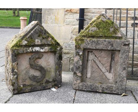 A Pair of Carved and Weathered Stone Gate Post Finials, 19th century, carved with the letters S and N beneath triangular pedi
