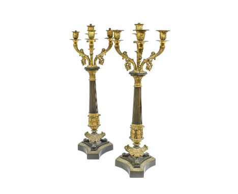 A Pair of Patinated Bronze and Parcel Gilt Empire Style Four-Light Candelabra, early 20th century, on tapering reeded pedesta