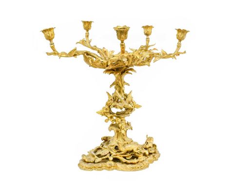 A Gilt Metal Six-Light Candleabra/Centre Piece, 19th century, with leaf-sheathed sockets and branches, on a cast and pierced 
