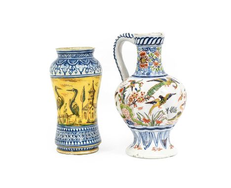 A Delft Ewer, 19th century, writhen moulded and painted in colours with birds in a continual landscape, AK mark29cm highAn Al