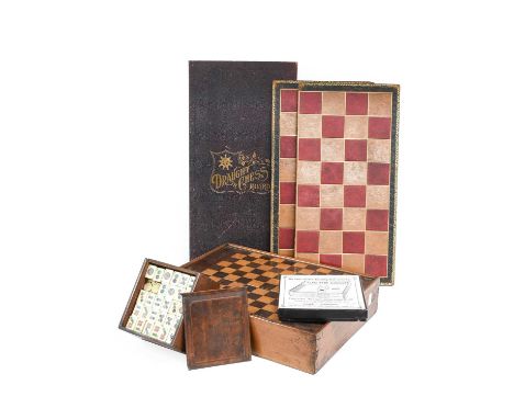 A Victorian Mahogany Boxed Games Compendium, the sliding cover inlaid in coloured woods with a chess board enclosing chess an