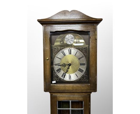 An oak and leaded glass Tempus Fugit longcase clock with pendulum and weights, height 204 cm 