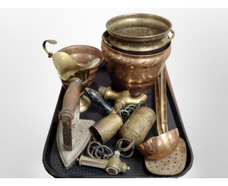 A group of copper and brass wares, pots, iron, ladle, bells etc 