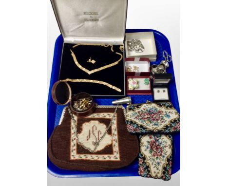 A gold plated necklace, bracelet and earring suite together with costume jewellery, lady's tapestry purses, thimble on stand 