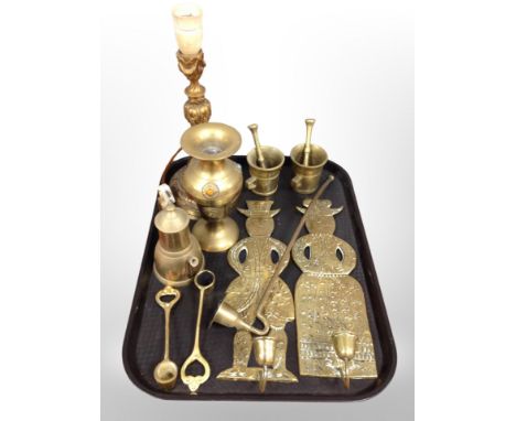 A group of brass ware, pair of figural candle wall sconces, pestles and mortars, vase, ornate lamp base 