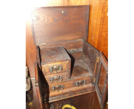 A VINTAGE OAK SMOKERS CABINET WITH ART NOUVEAU COPPER HANDLES 